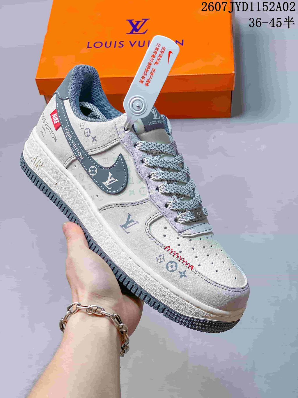 Close-up of a light gray sneaker with printed panels, contrast Swoosh, and patterned laces