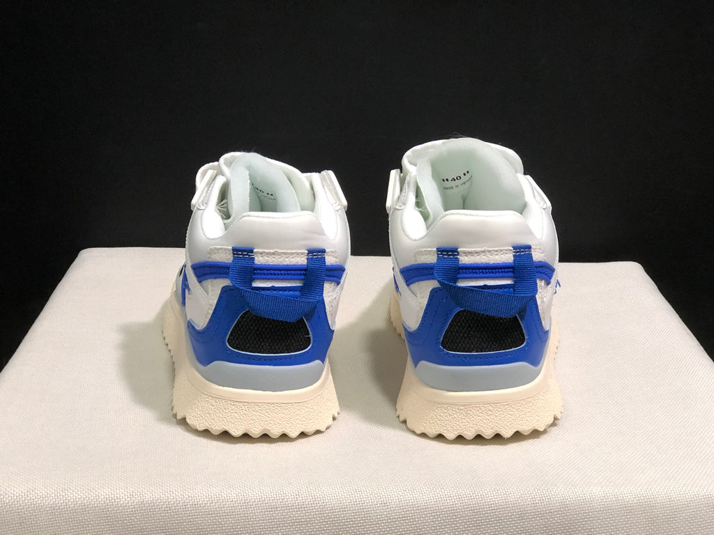Rear view of the pair showing blue heel details, padded collars, black heel openings, and textured outsoles.