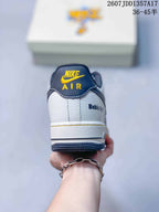Rear view of the sneaker showing the yellow tongue branding, white heel panel, and dark outsole.