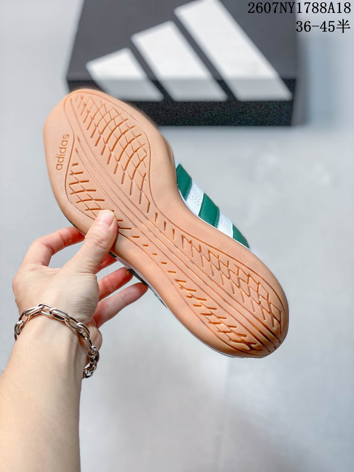 Bottom view of the gum-colored adidas trainer outsole showing its textured tread pattern