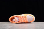 Top view of the sneaker showing the perforated toe box, tongue, and orange laces.