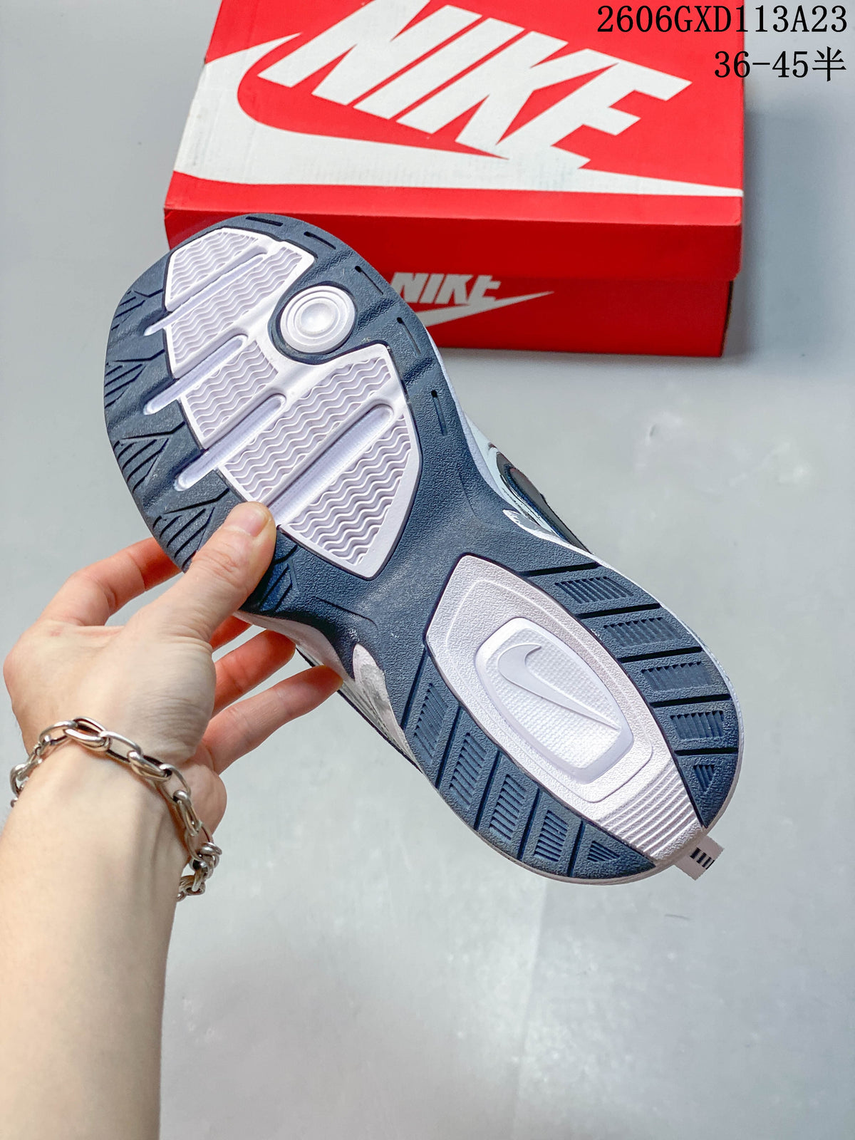 Underside of a Nike Air Monarch IV sneaker showing the patterned navy and white outsole.