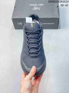 Front view of the shoe showing the toe, laces, and textured upper