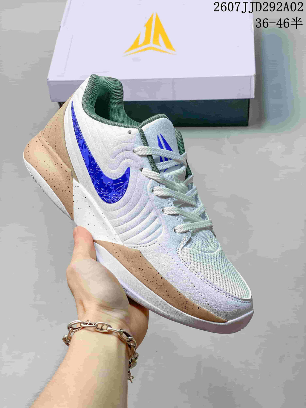 White Nike JA 2 basketball shoe with a blue Swoosh and tan speckled midsole detailing.