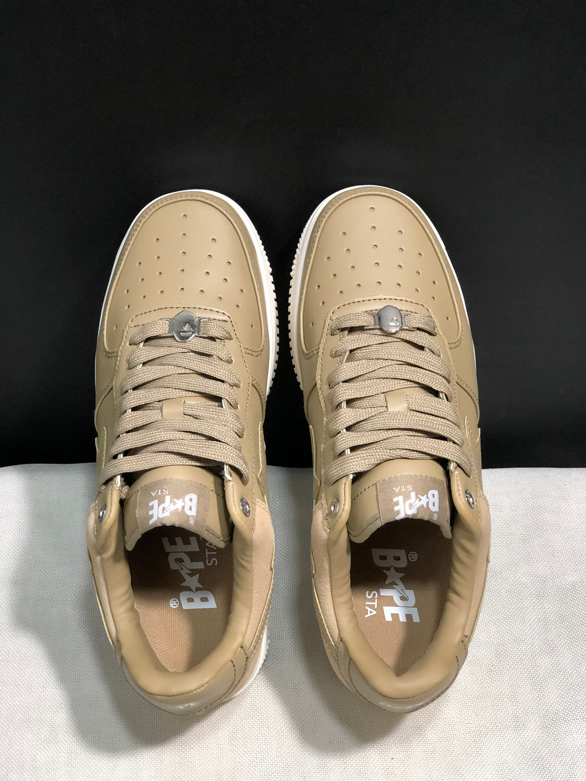 Top view showing the perforated toe panels, tonal laces and branded insoles.