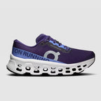 Studio-style side profile of the purple and blue On Cloudmonster 3 shoe against a light background.