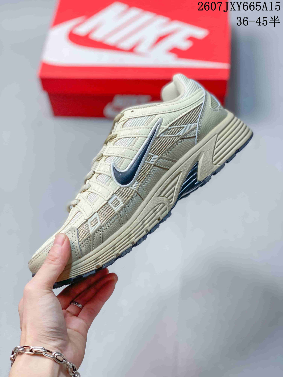 Side profile showing the cream layered upper, mesh panels, navy Swoosh, and sculpted midsole.