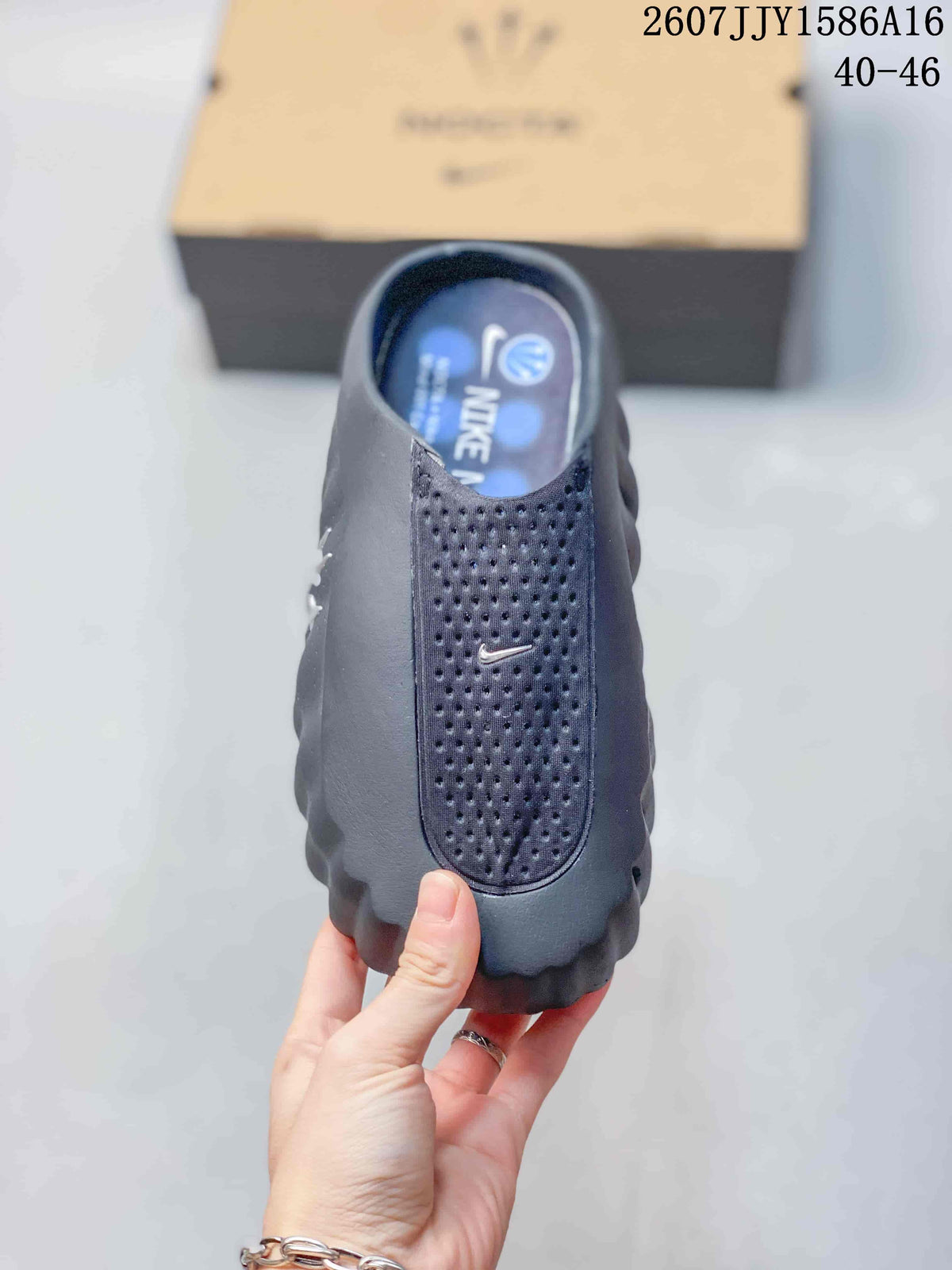 Front view of a single slide showing the perforated upper panel, Nike Swoosh detail, and open heel.