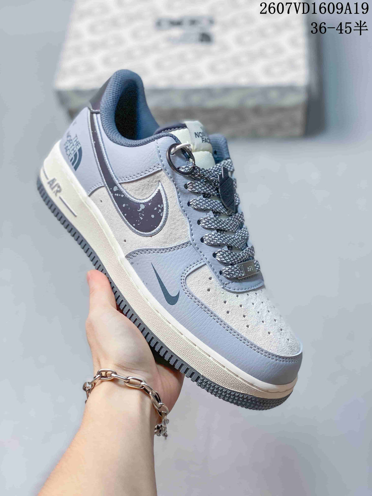 Angled side view showing the contrasting Swoosh, speckled detailing, The North Face branding, and AF1 midsole marking.