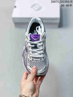 Top view of a Saucony Progrid Omni 9 sneaker showing white laces, mesh-style panels and a purple tongue label.