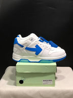 Side view of the white and blue low-top sneakers showing the contrasting arrow detail and blue outsole.