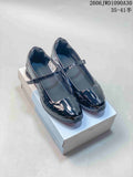 Pair of glossy black Nike Shox Z Calistra Mary Jane-style shoes with instep straps