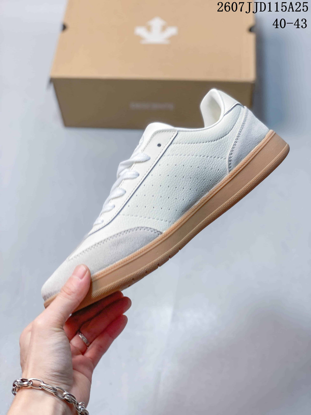 Side profile showing the white and light grey upper, low-top shape, laces, and gum-colored sole.