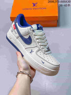 Angled side view showing the white and blue sneaker's patterned panels