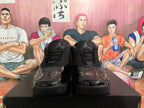 Front view of black Jordan sneakers with textured tongues, black laces, glossy toe panels, and Jumpman logos.