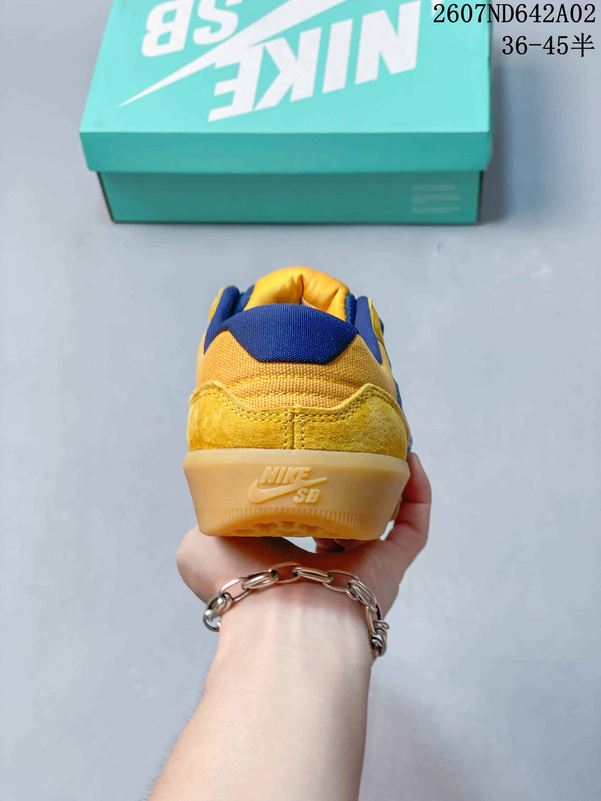 Rear view of the yellow Nike SB Force 58 shoe with a gum-colored heel outsole