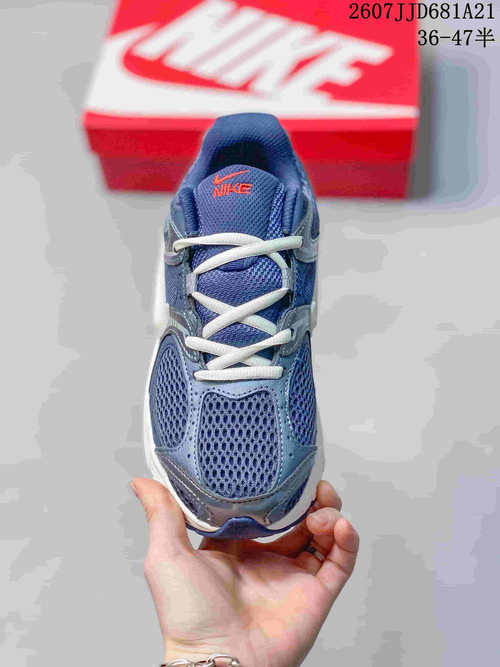 Top view of a blue Nike V5 RNR sneaker showing white laces, mesh-style forefoot panels and orange tongue branding.