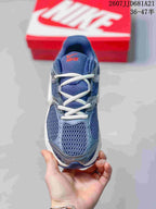 Top view of a blue Nike V5 RNR sneaker showing white laces, mesh-style forefoot panels and orange tongue branding.