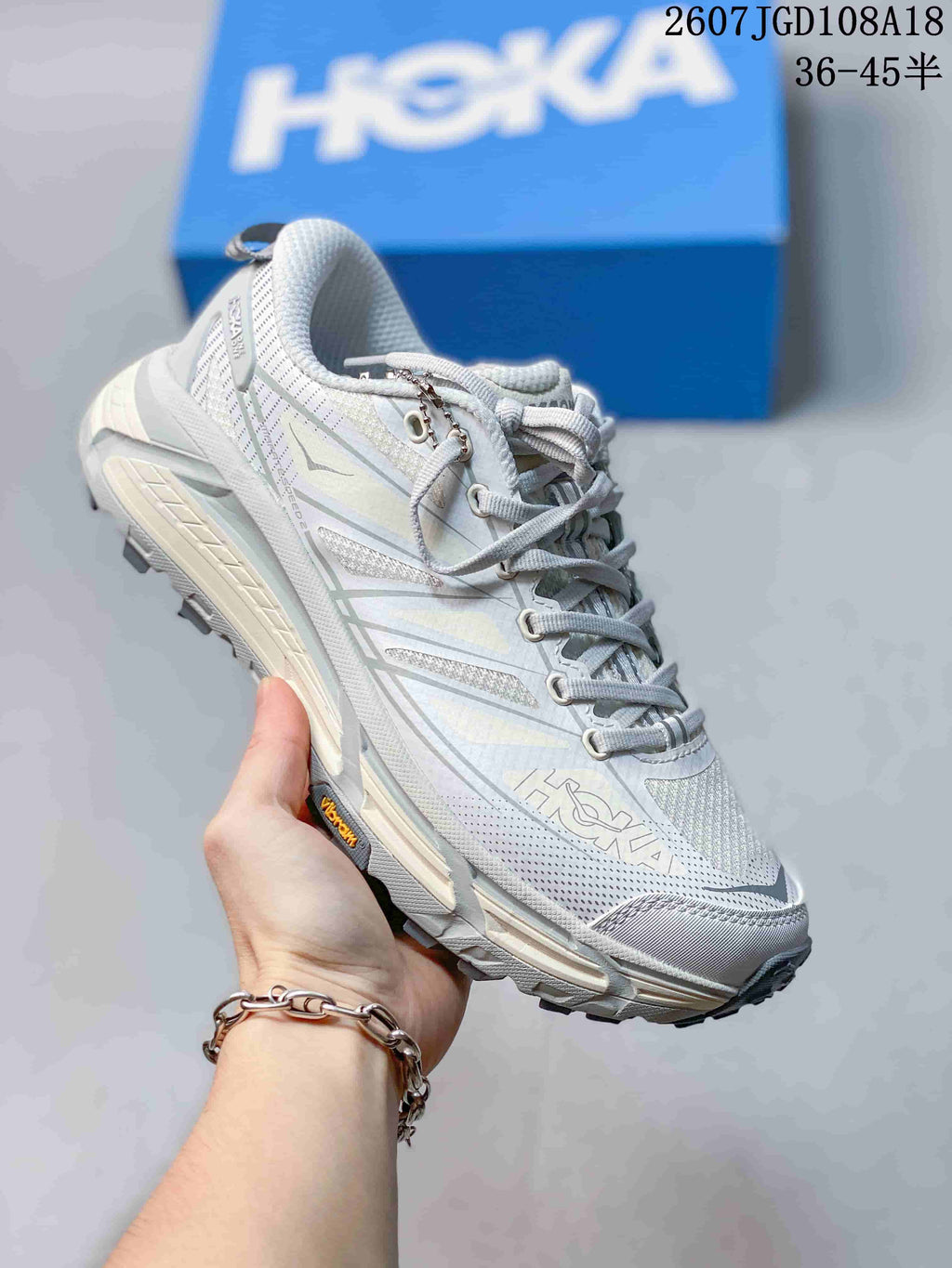 White and light gray HOKA Mafate Speed 2 sneaker shown from a close angled side view.