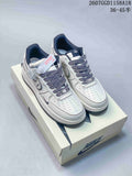 Pair of white and navy Nike Air Force 1 '07 low-top sneakers displayed on a Nike shoebox.