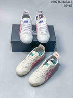 Multiple views of white and pink Onitsuka Tiger Mexico 66 Deluxe sneakers arranged around a branded shoe box; image text shows style code 2607JGD335A15 and size range 36–45.