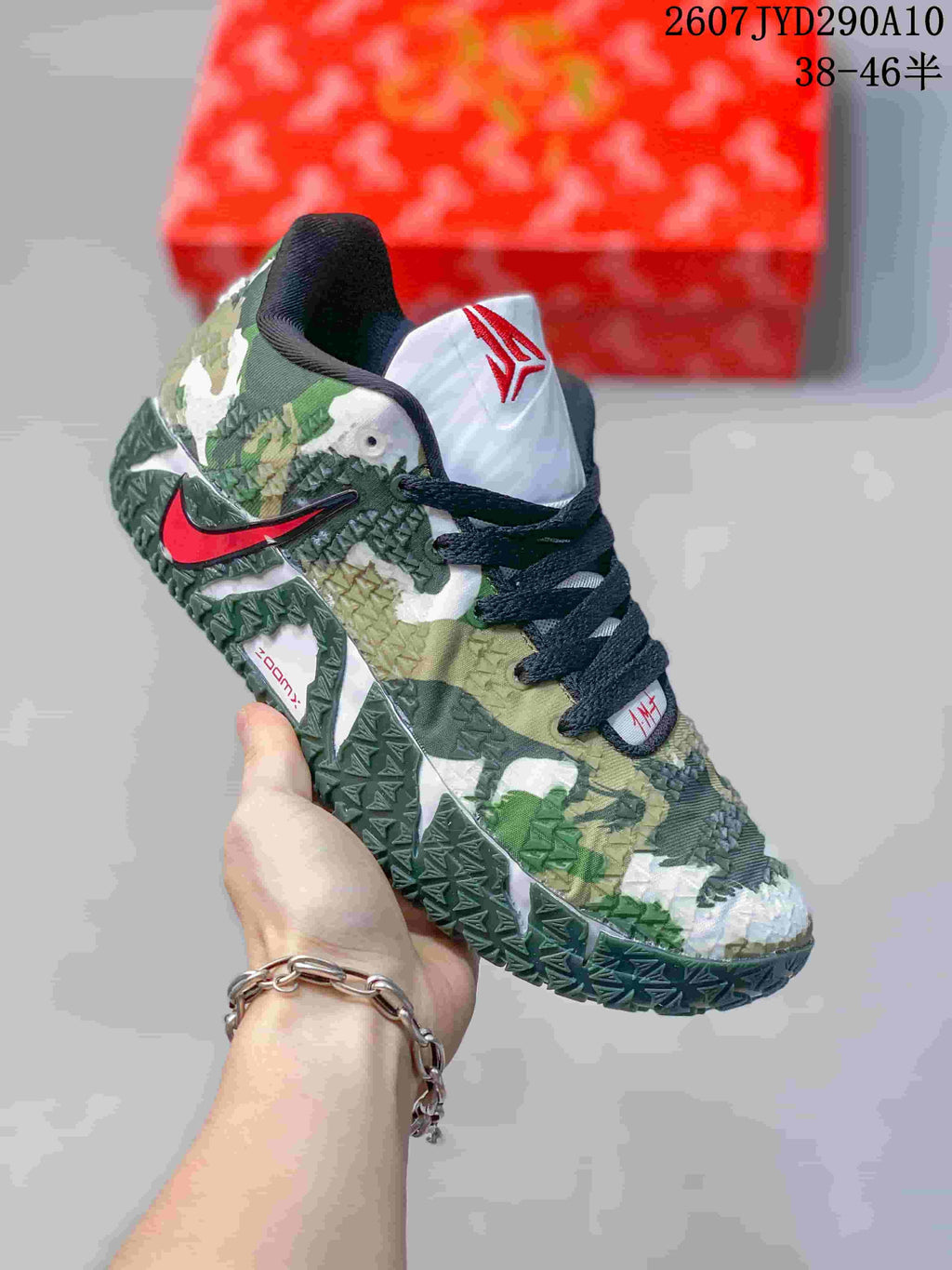 Angled side view showing the red Swoosh, Ja branding, camouflage-style upper, and green outsole.