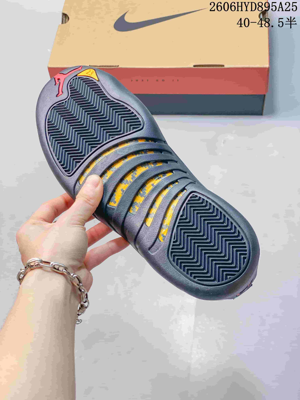 Close-up of the shoe outsole showing patterned tread and yellow accent sections.
