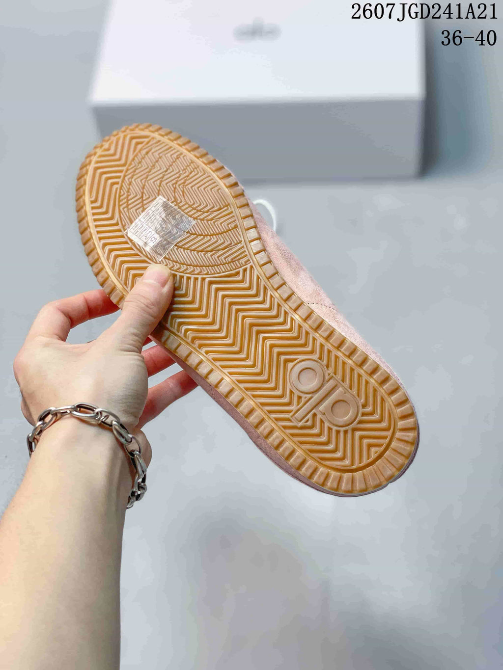 Close view of the gum-colored outsole showing its geometric traction pattern.
