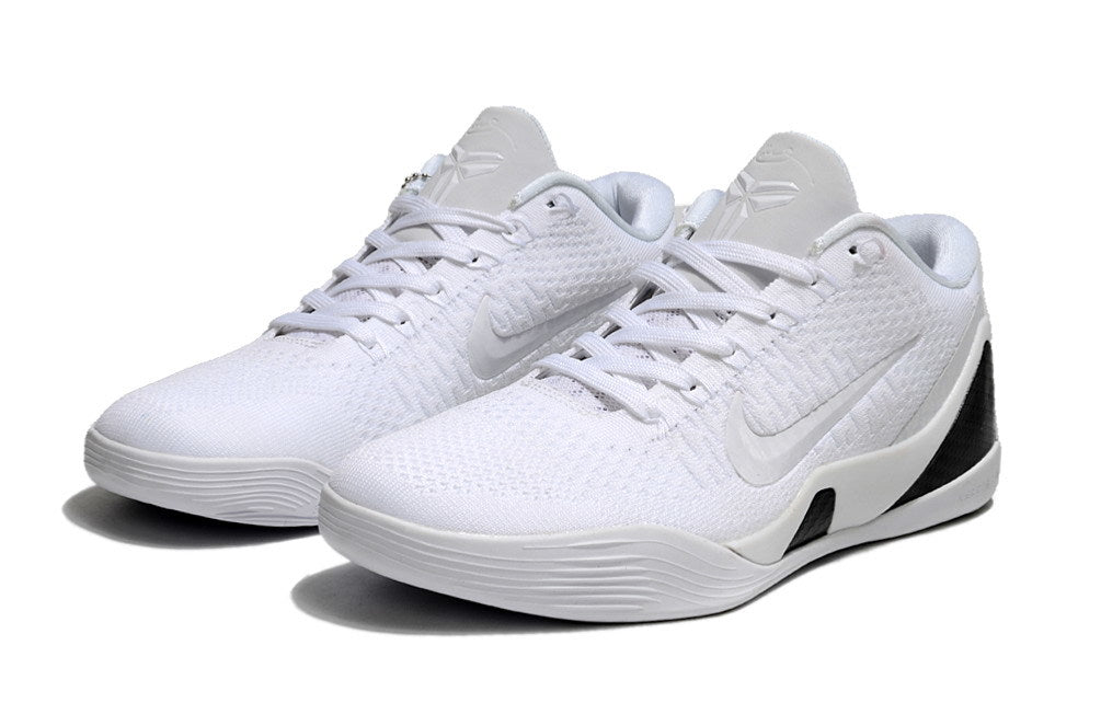 Pair of all-white low-top shoes shown from the front.