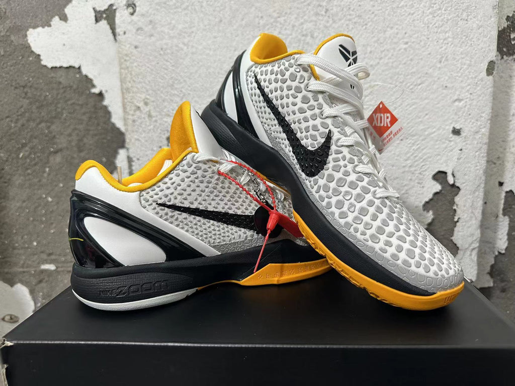 Angled view of the pair highlighting the white, gray, black, and yellow color scheme
