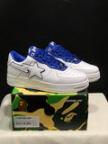 Pair of white and blue BAPE STA low-top sneakers displayed on a patterned BAPE shoebox; the box label shows EU 41, UK 7, US 8, and CM 26.