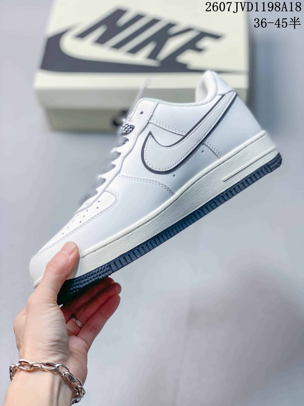 Side profile showing the white upper, outlined Swoosh and layered midsole.