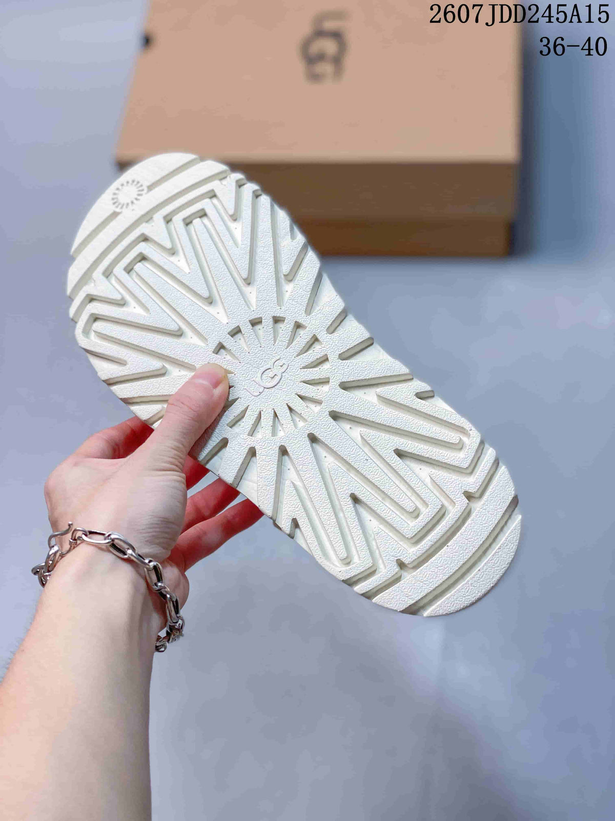 Close view of the sandal outsole showing a raised geometric lug tread and embossed branding.