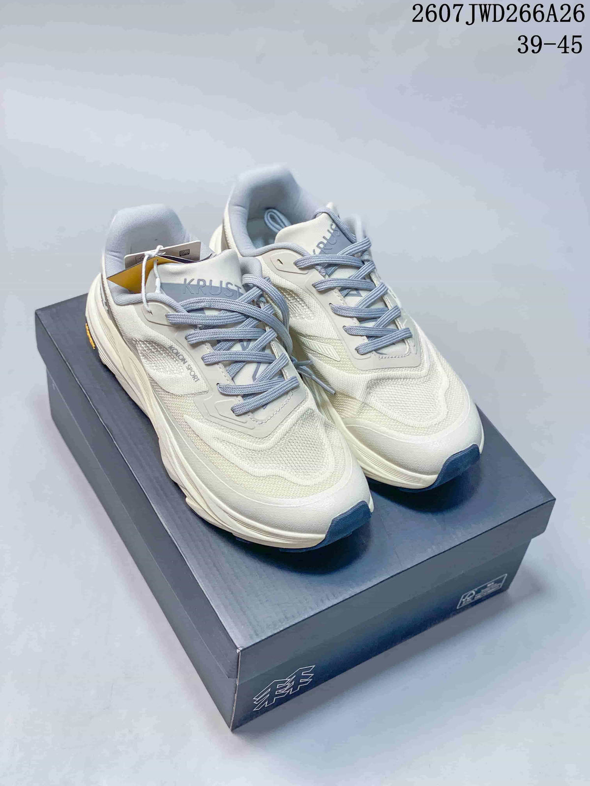 Pair of off-white KOLON SPORT KRUST trail running shoes displayed on a shoebox, with navy outsole accents and the style code and size range visible above.