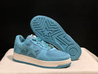 Angled view of the sneakers with one shoe lifted to display the blue outsole's geometric tread pattern and star motif.