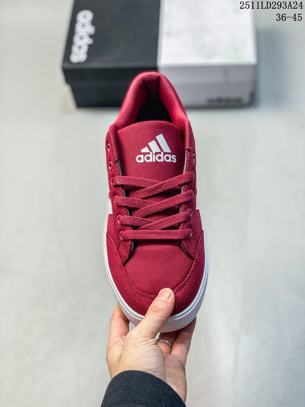 Top view of the red lace-up sneaker showing the adidas tongue logo and rounded toe.