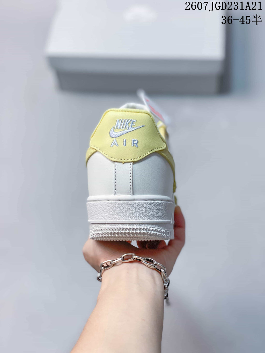 Rear view showing the pale yellow heel tab with Nike Air branding and the white midsole.