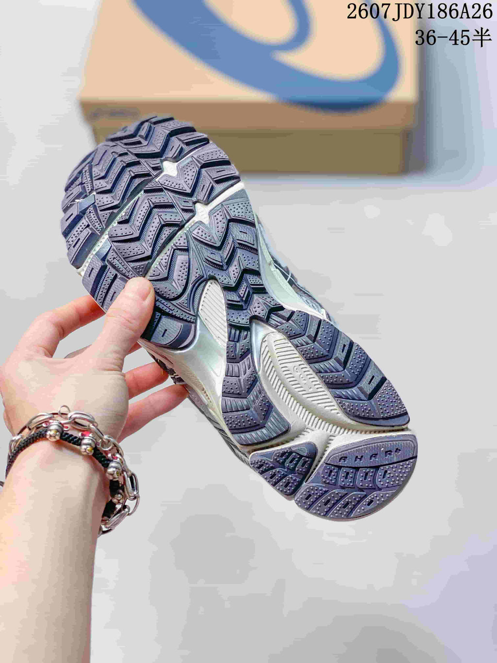 Underside view of an ASICS Gel-Kahana 8 FL sneaker showing the segmented lugged outsole pattern.