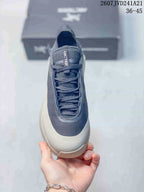 Top view showing the lace-up construction, padded tongue, dark navy upper, and light-colored toe area.