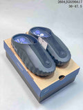Pair of black and dark gray Nike Mind 001 slides displayed on a presentation box; the image shows the printed range 36–47.5.