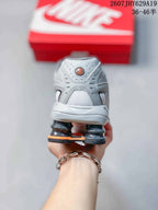 Rear view showing the grey heel, padded collar and columned heel structure of the sneaker.