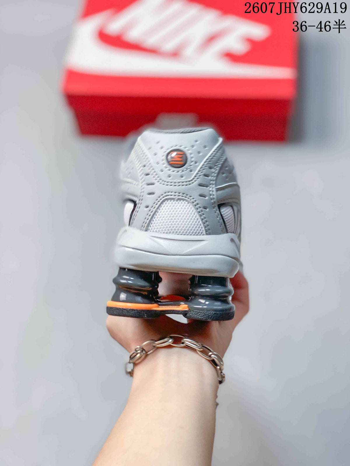 Rear view showing the grey heel, padded collar and columned heel structure of the sneaker.