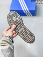 Close-up of the patterned gum-colored outsole with circular forefoot detailing and adidas branding.