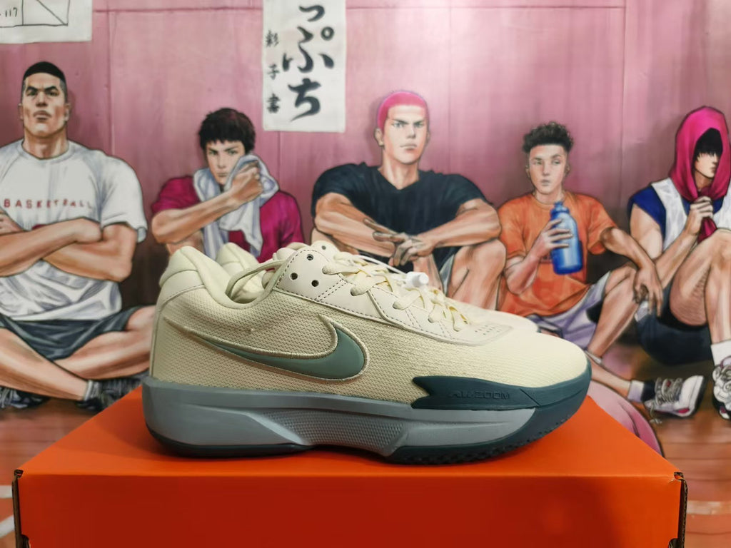 Side profile of a light beige Nike shoe with gray and teal accents and a visible side Swoosh.