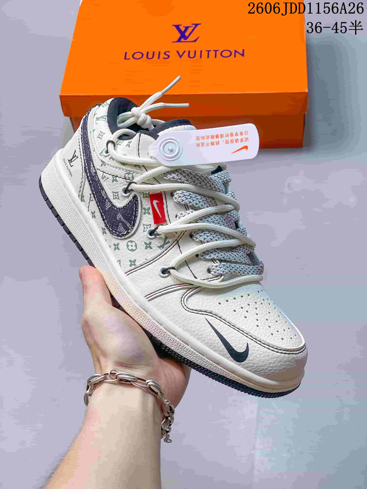 Angled side view showing the white textured upper, dark Swoosh-style overlay, monogram pattern, and orange shoebox.