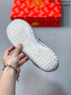 Close view of the white outsole with a repeated textured traction pattern.