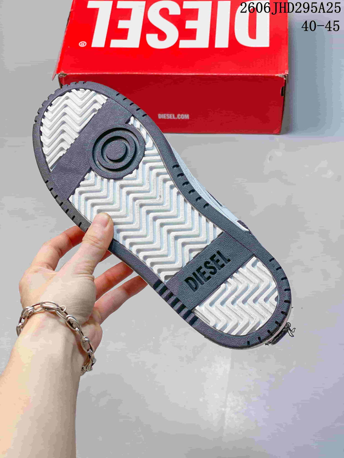 Close view of the sneaker outsole with a white zigzag tread pattern and dark Diesel-branded sections