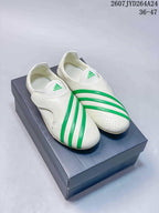 Pair of off-white and green adidas Virginia Vario Flat Earther shoes displayed on a shoebox.