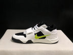 Lateral profile showing the low-top silhouette, midfoot strap, black outsole, and green side detail.