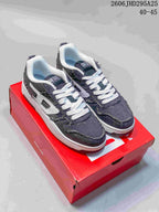 Pair of charcoal Diesel S-UKIYO V2 low-top sneakers with white laces on a red box